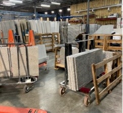 Stone slabs and fabrication racks on the Hard Surfaces shop floor