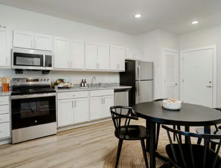 The Shelby Nashville apartment kitchen with white cabinets and granite countertops